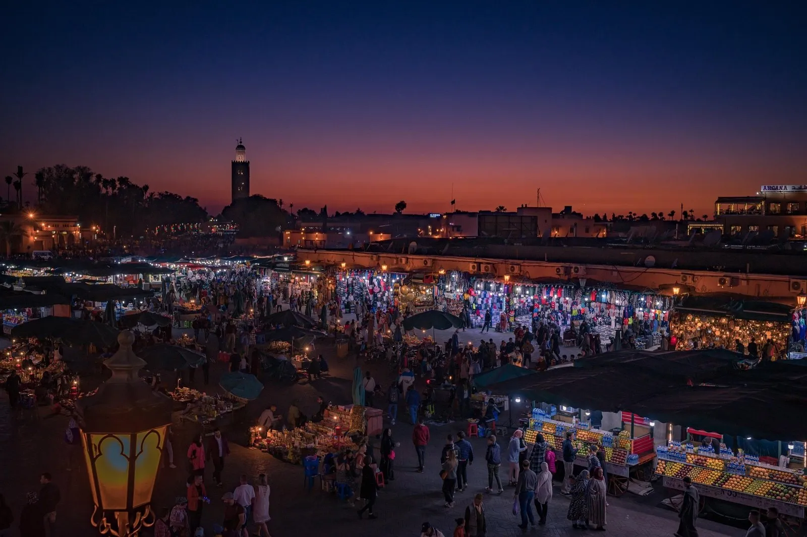 Jemaa el-Fna square in Marrakech at dusk with the Koutoubia minaret